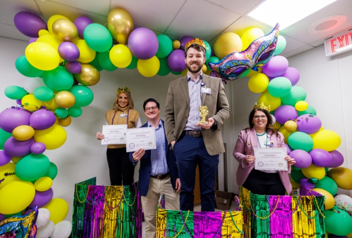 Walton Mallette (center right) and Josh Clark (center left) pose with the Patient Safety Week award and certificate.